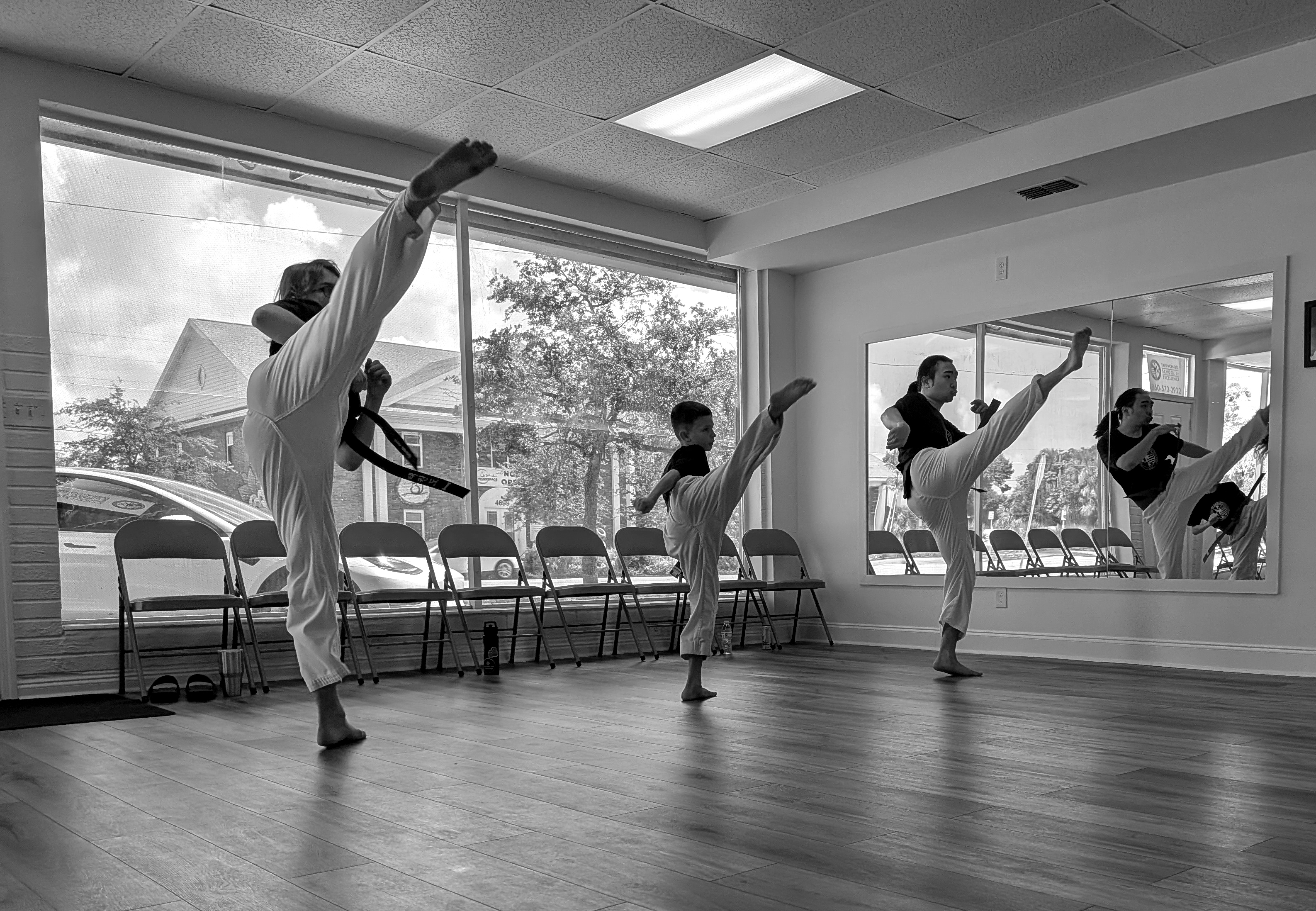 3 students performing a side rising up kick